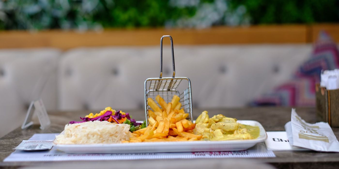 A halal meal of rice, fries and chicken curry
