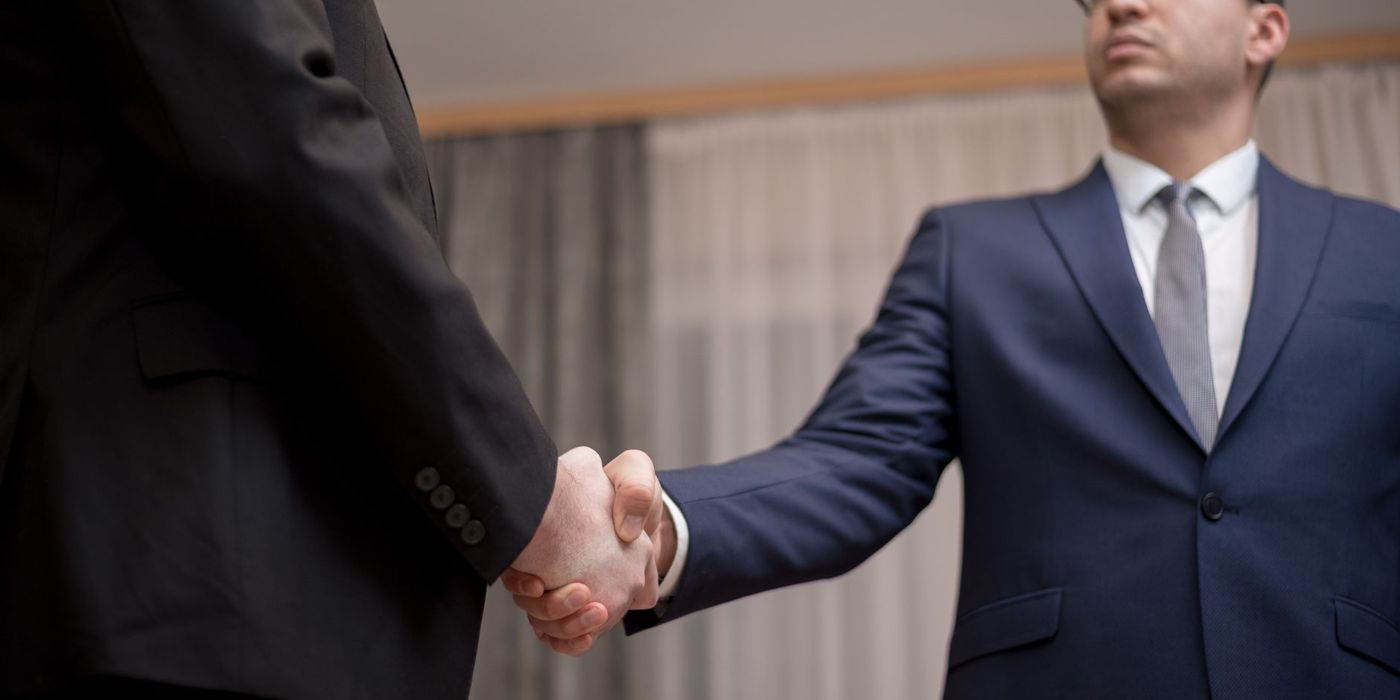 Two officials shaking hands on an agreement