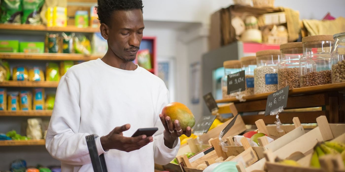 Using a phone to check a product while grocery shopping