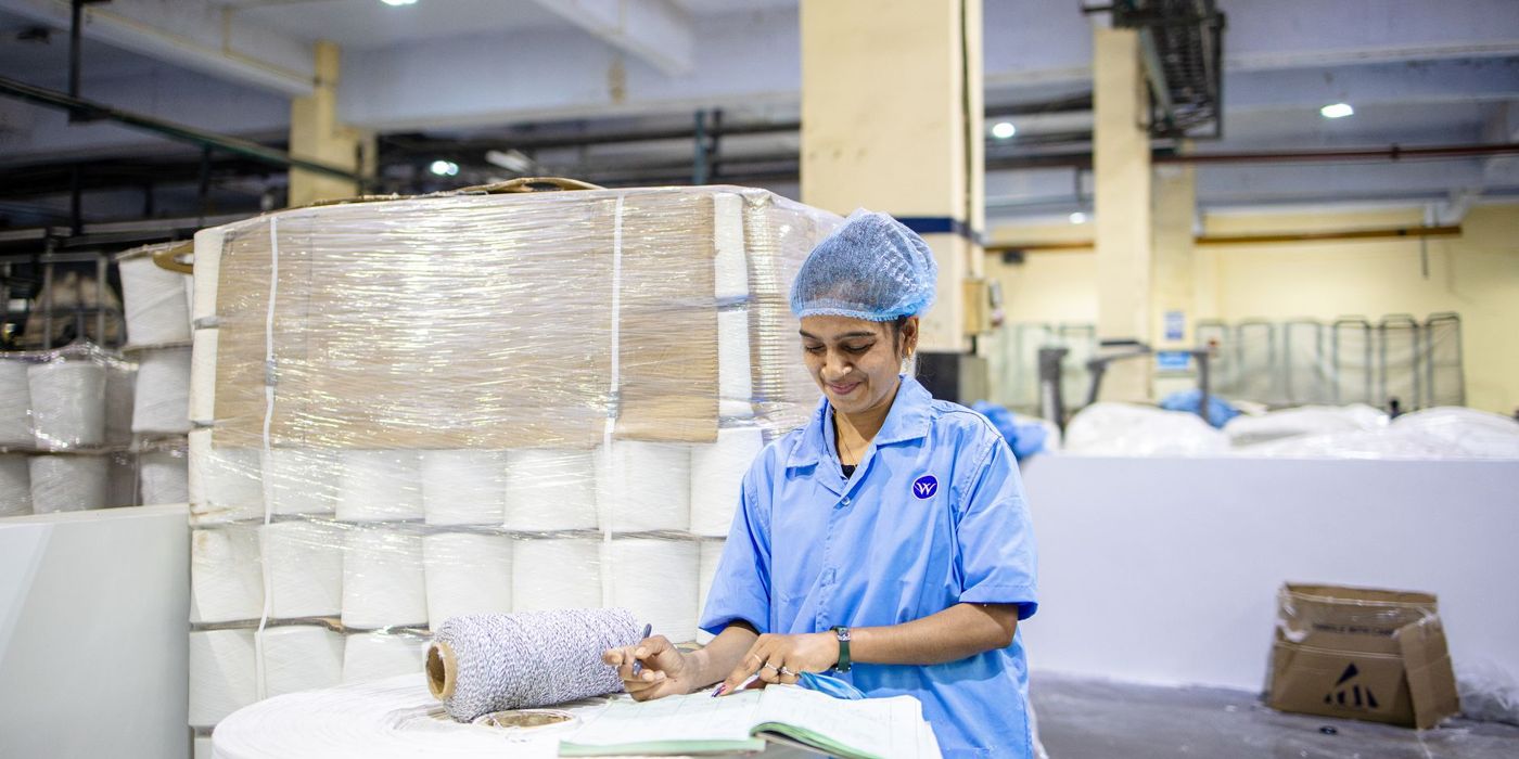 A factory quality inspector recording checks in a logbook